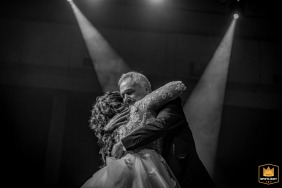 A bride in Thessaloniki, Greece, is shown with her father in a black and white portrait. 